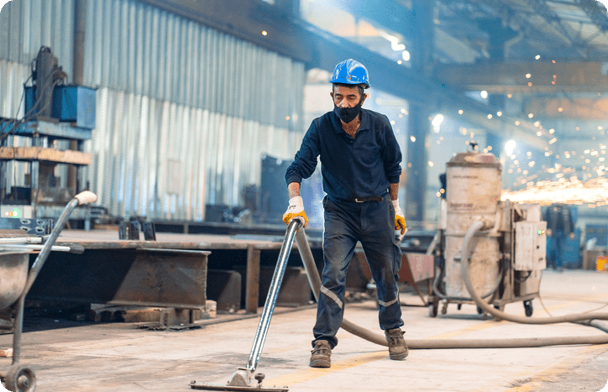 Man in hard hat operating floor cleaner
